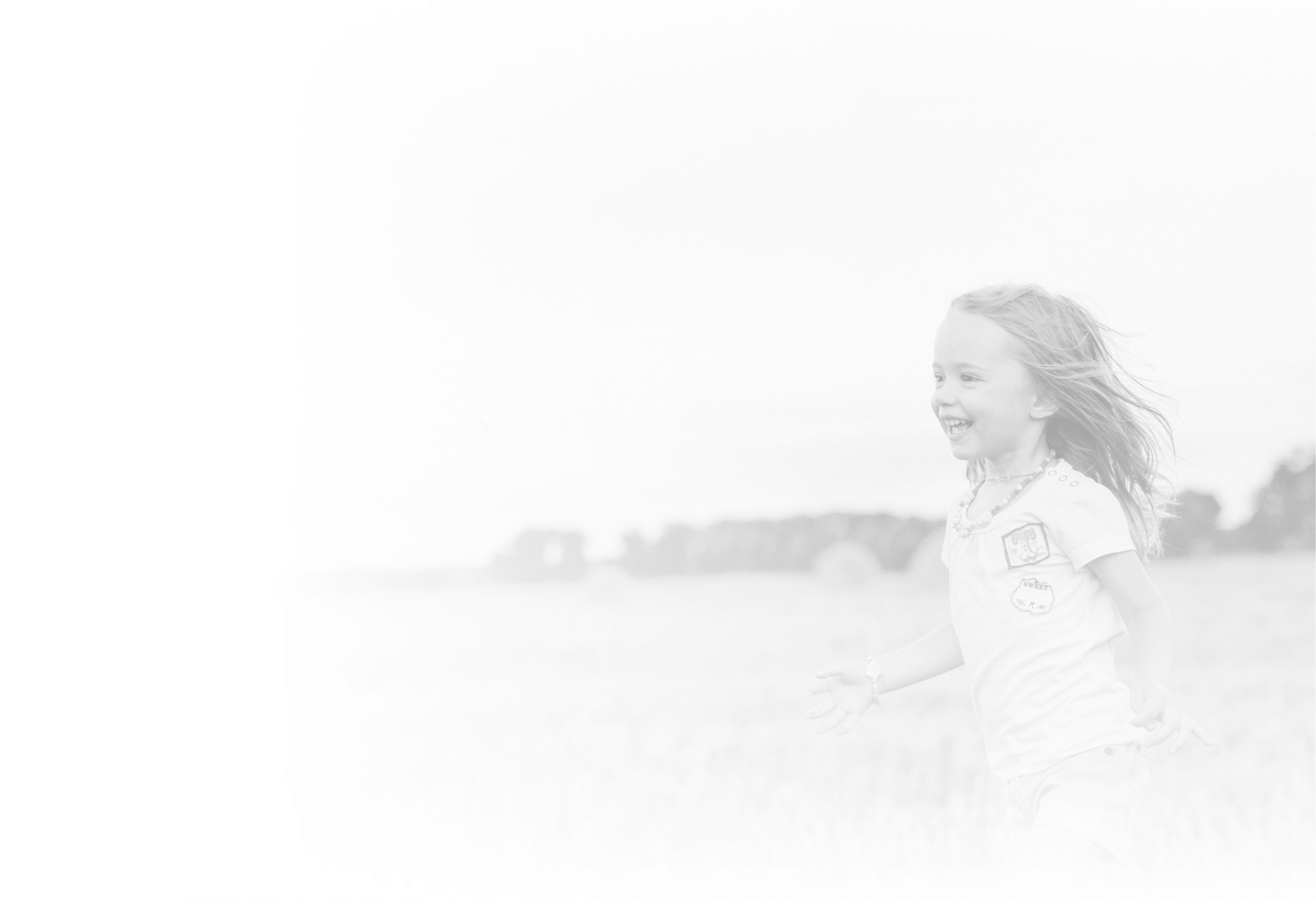 Little girl running in a field.